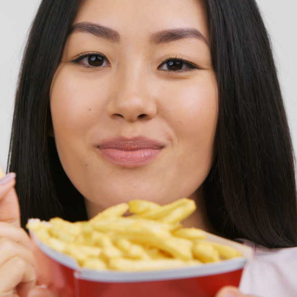Asian woman enjoying french fries